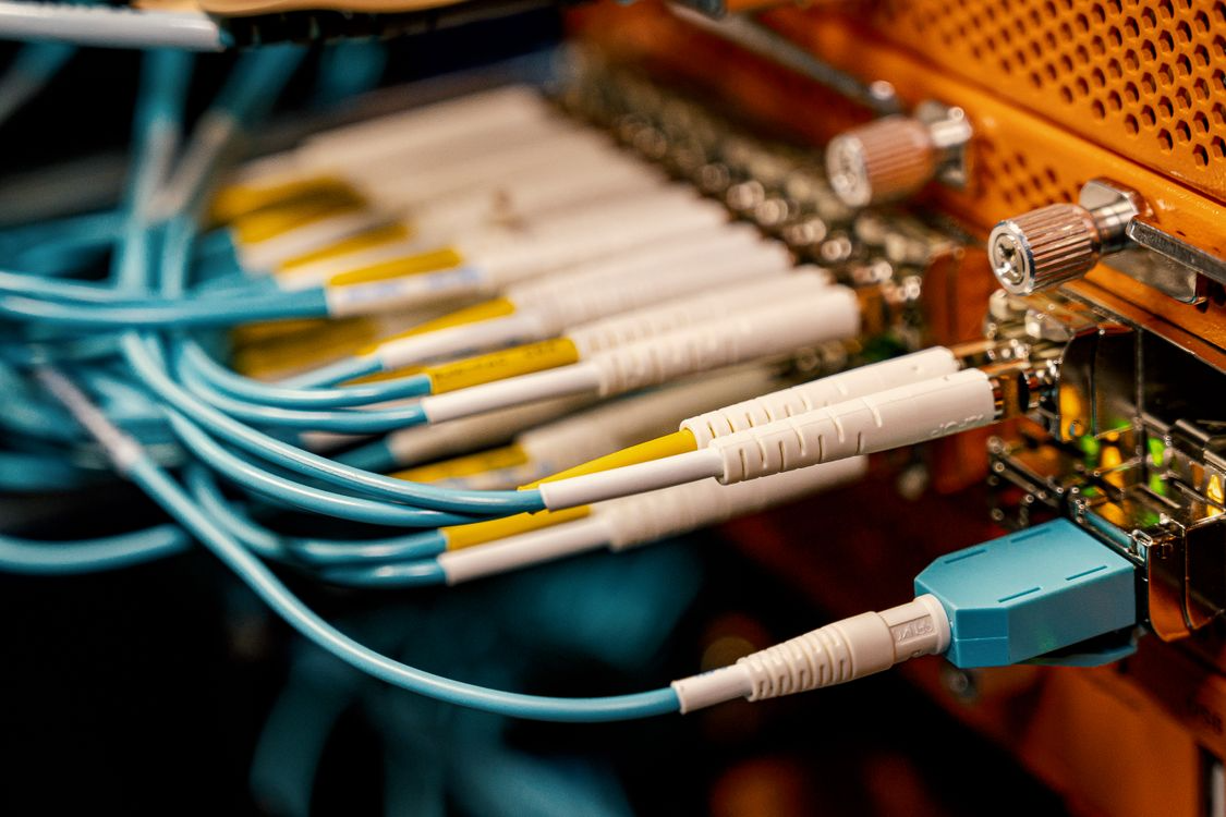 Fiber-optic cables connected to network equipment